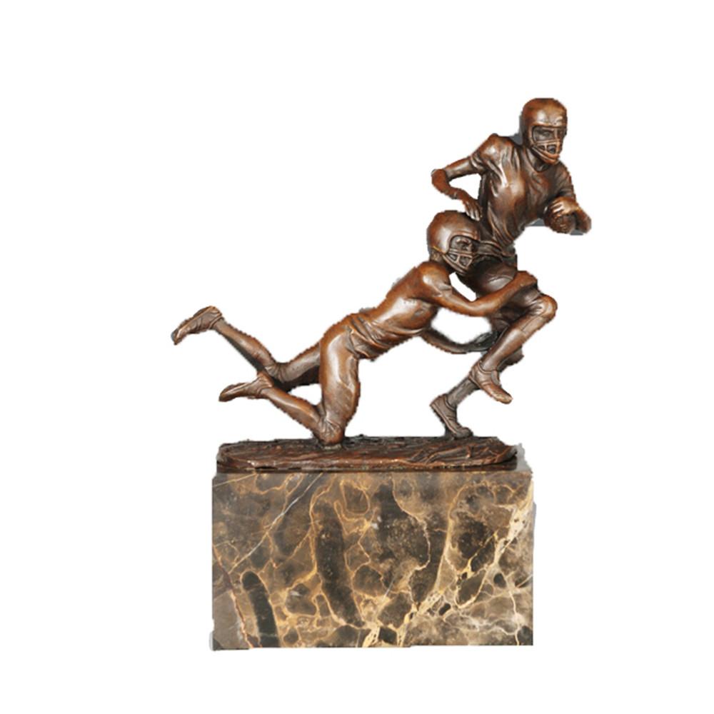 This is a bronze American football confrontation sculpture.The sculpture presents the dynamic competitive pose of two athletes: one running with the ball, the other diving to tackle, with realistic details of football helmets and sports gear, and body lines full of explosive power, accurately restoring the confrontation tension of American football. It is a decorative ornament themed around ball competitive sports, suitable for display in homes or sports-related spaces.