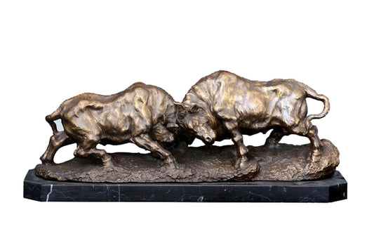 This is a bronze sculpture depicting two bulls locked in a fierce struggle, their horns clashing as they vie for dominance. The bulls are rendered with remarkable detail—their muscles bulge powerfully, and the texture of their fur is intricately captured in the bronze, conveying a raw sense of strength and ferocity.