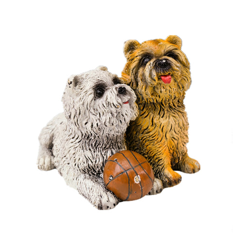This is a bronze dog sculptures, depicting an interactive scene of two cute puppies. One is grayish-white, and the other is brownish-yellow. Their fur textures are delicate and realistic. They are around a brown basketball, with the brownish-yellow puppy sticking out its tongue, looking lively and playful. The overall style is cute and warm, with vivid details, conveying a cheerful atmosphere, and it has strong ornamental and fun value.