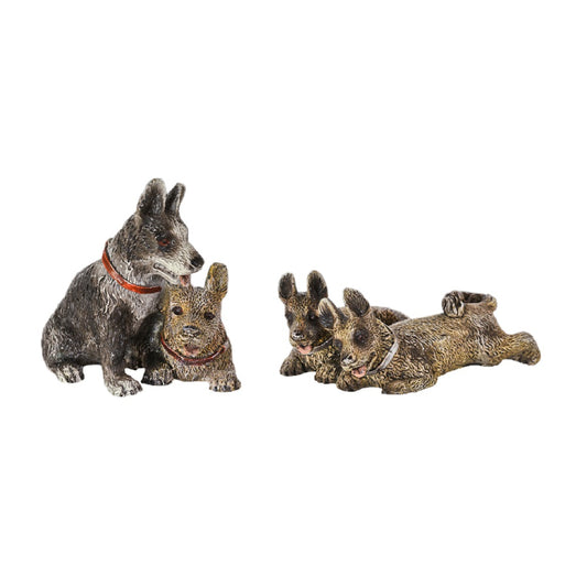 This is a set of bronze dog sculptures, depicting an interactive scene of multiple puppies. On the left, there are two puppies: one is gray-black with a red collar, and the other is brown with a red collar, looking intimate. On the right, two brown puppies are in a lying posture, looking lively and playful. Their fur textures are delicate and realistic. The overall style is cute and warm, with vivid details, conveying a cheerful atmosphere, and it has strong ornamental and fun value.