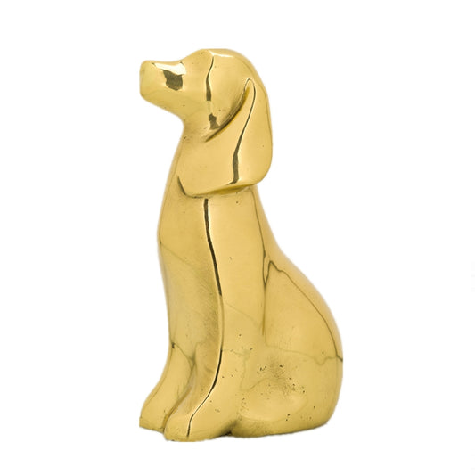 This is a brass dog sculpture in an abstract style. The dog is in a sitting posture, with a simple and smooth shape. Its surface has a metallic luster, and the lines are concise and neat, with a quiet and modern artistic demeanor. The overall craftsmanship is exquisite. Through the minimalist shape and metallic texture, it shows a unique artistic charm and has high decorative and ornamental value.