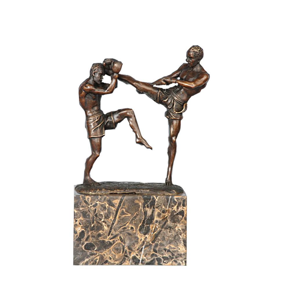 This is a bronze Muay Thai sparring sculpture. The sculpture presents the dynamic confrontation pose of two Muay Thai fighters—one lifting a leg to attack, the other raising arms to defend, with realistic details of gear like Muay Thai shorts and gloves, and body lines that are tight and full of combat tension, accurately restoring the competitiveness of combat sports. It is a decorative ornament themed around combat sports, suitable for display in homes or sports-related spaces.