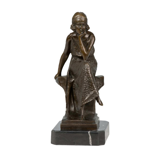 This is a bronze sculpture of a seated woman. She wears a headscarf and a dress with textured decorations, sitting in a relaxed posture, with one hand resting on her cheek in a thoughtful demeanor. The textures and folds of the clothing are delicately and realistically depicted. Featuring characteristics of early 20th-century Art Deco style, this work is often used as a European-style home decorative ornament, combining artistic beauty and decorative value.