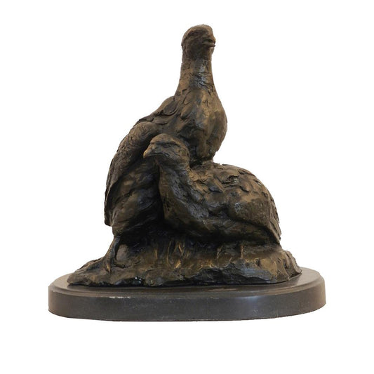 This is a bronze sculpture depicting two birds. One bird stands, while the other lies half-reclined, interacting intimately as if cuddling in nature. The bronze surface features a rough and textured finish, with exquisitely detailed feathers that make the birds appear vivid and realistic.